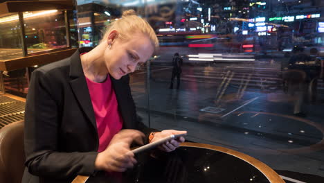 Time-lapse-shot-of-woman-sitting-in-cafe-using-touch-pad-on-the-city-background-Seoul-South-Korea