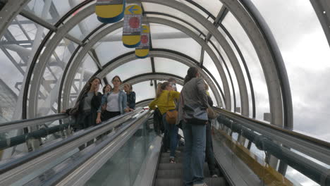 People-riding-escalators-in-glass-tube