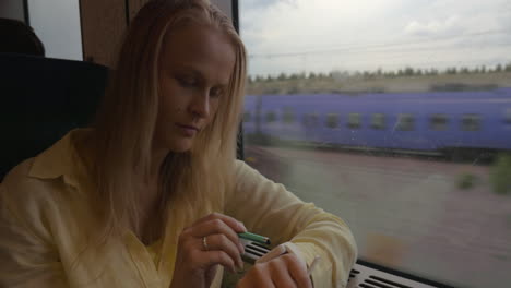 Woman-using-smart-watch-during-train-ride