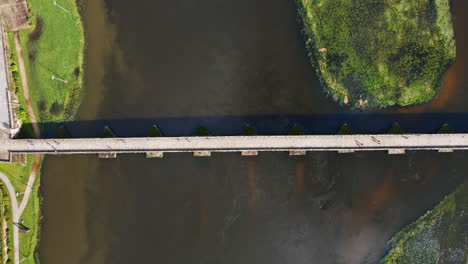 Stunning-top-down-aerial-4K-drone-footage-of-a-village---Ponte-de-Lima-in-Portugal-and-its-iconic-landmark---Stone-roman-bridge-crossing-over-the-Lima-River