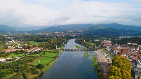 Stunning-aerial-4K-drone-footage-of-a-village---Ponte-de-Lima-and-its-iconic-stone-bridge-crossing-over-the-Lima-River