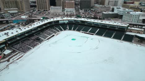 Overhead-4K-Drone-Shot-of-a-Sports-Baseball-Arena-Diamond-Covered-in-Snow-Closed-and-for-Winter-in-Shaw-Park-Downtown-Winnipeg-Manitoba-Canada