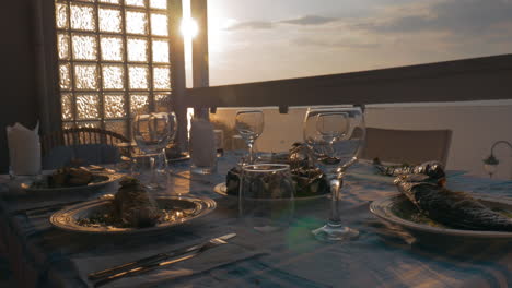 At-sunset-in-city-of-Perea-Greece-dinner-table-served-with-cooked-fish