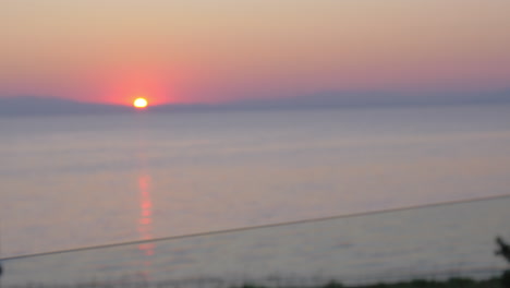 Clinking-glasses-of-champagne-against-sunset-sea-Piraeus-Greece