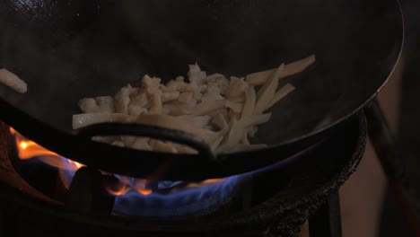Making-noodles-dish-in-wok-on-gas-fire-Thailand