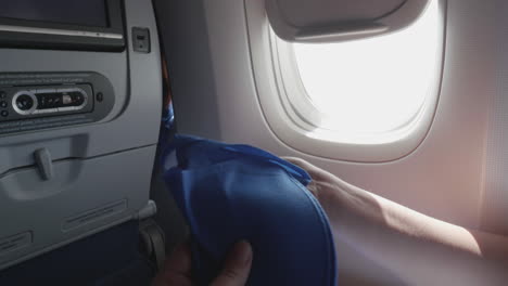 Shot-of-woman-opening-disposable-slippers-in-airplane