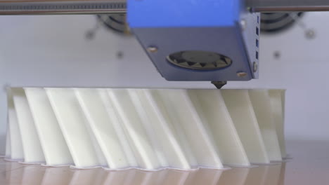 3D-printing-equipment-making-white-plastic-object