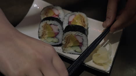 Serving-sushi-rolls-in-Japanese-restaurant