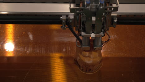 Close-up-of-mechanism-of-3D-printer-working-on-printing-plastic-toys