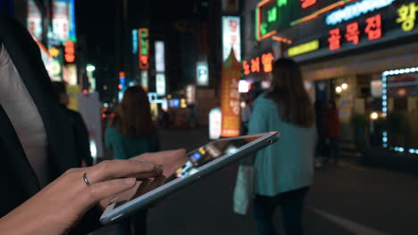Woman-browsing-in-web-on-pad-in-night-Seoul-South-Korea