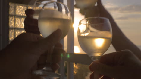 Family-celebrates-raising-their-glasses-of-white-wine-in-city-Perea-Greece