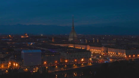 Turin-city-at-night,-nighttime-skyline-overview,-Mole-Antonelliana-tower-view