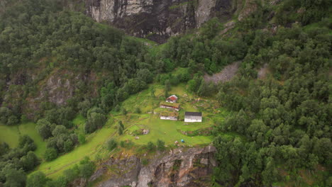tiny-farm-house-on-mountain-ridge,-skageflå-farm-at-Geirangerfjord,-geiranger,-Norway