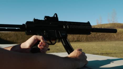 reloading-gun,-changing-mags,-ammo-switch-on-Sig-MPX-K-suppressed-Karabin-GSG-15-BLACK-sunny-blue-sky-shooting-range