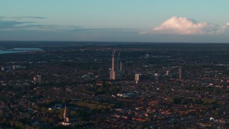 Aerial-slider-shot-of-singular-tall-building-being-built-in-walthamstow-london-suburbs