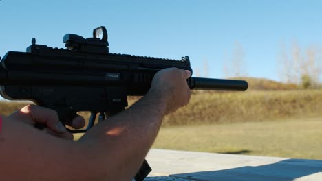 shooting-bullet-singleshot-from-Sig-MPX-K-suppressed-Karabin-GSG-15-BLACK-on-sunny-blue-sky-shooting-range
