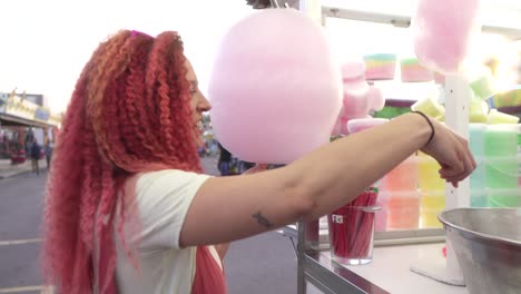 woman-pays-for-cotton-candy-at-a-fair-stall