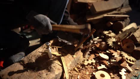Hand-crafting-man-working-on-raw-wood-material-with-gloves-close-up