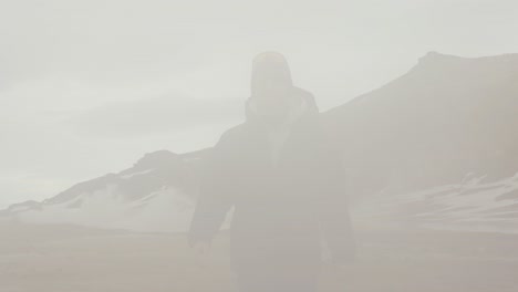 Male-fearlessly-walk-through-dense-vapor-cloud-from-Icelandic-steam-vent