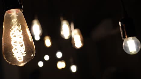 Close-up-rotation-around-lightbulb-reveals-bokeh-lights-in-dark-room