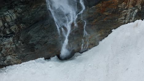 Flying-over-waterfall-stream-flowing-at-Fellaria-glacier-in-Valmalenco-of-Valtellina,-Italy