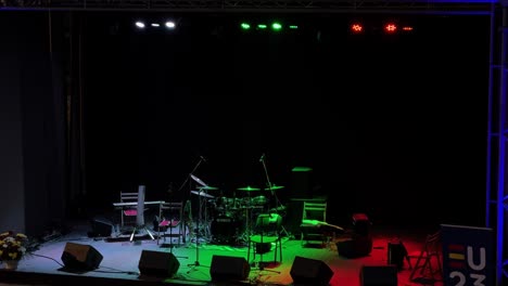 Empty-colorful-concert-stage-with-no-people-and-prepped-with-instruments-and-mics-to-start-a-concert