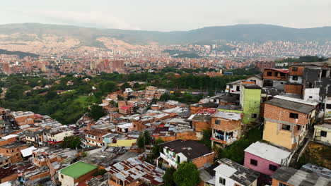 Aerial-view-passing-colorful-slum-dwellings-in-Comuna-13,-in-Mendellin,-Colombia