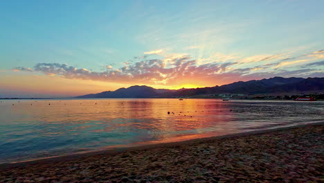 Colorful-sunset-at-a-beach,-on-the-coastline-of-the-red-sea,-in-Dahab,-Egypt