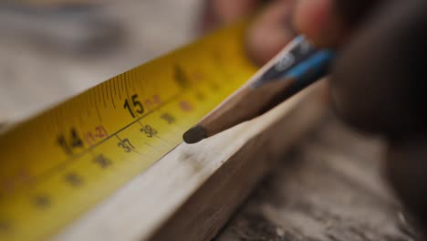 Slow-motion-close-up-of-carpenter-measuring-wood-panel