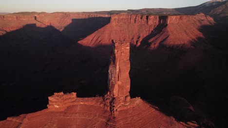 Long-aerial-view-of-iconic-Castleton-Tower-rock-spire-in-Moab-sunset