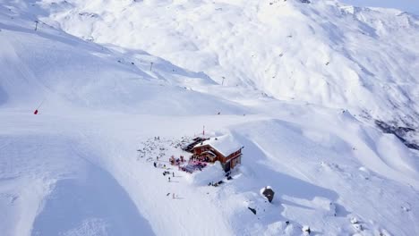 Flying-towards-the-cabin-by-the-ski-slopes,-in-the-French-Alps-in-Val-Thorens
