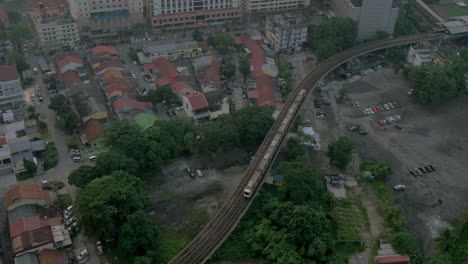 Bird-eye-view-of-poor-district-and-riding-train-on-railways-and-then-up-to-the-modern-district-with-skyscrapers-Kuala-Lumpur-Malaysia