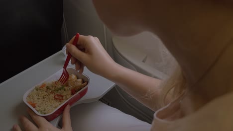 Woman-having-dinner-in-the-airplane