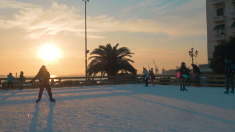 People-skating-on-ice-rink-at-sunset-Greece