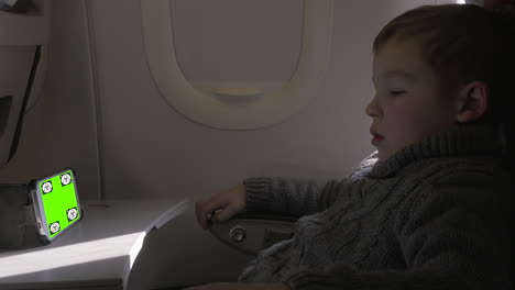 Child-watching-something-on-smartphone-in-the-airplane-Chroma-Key