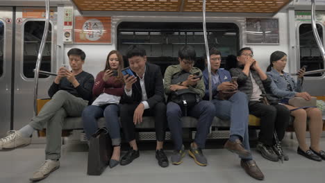 Commuters-using-mobile-phones-in-subway-Seoul-South-Korea