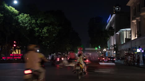 Timelapse-of-night-city-seen-busy-road-with-passing-cars-motorcycles-and-cyclists