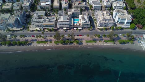 Aerial-drone-video-of-drone-looking-down-onto-coastal-promenade-next-to-sea