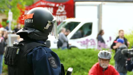 La-Policía-Antidisturbios-De-Quebec-Se-Sitúa-Delante-De-Los-Manifestantes-Con-Un-Cartel-Comunista.