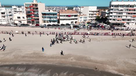 Aerial-view-captures-camargue-horse-riders-weave-through-beach-at-Feria-Palavas