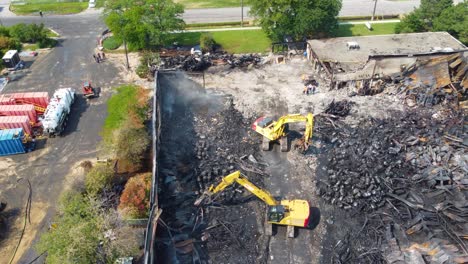Heavy-machinery-excavators-demolishing-burnt-building-and-removing-debris