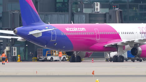 Aircraft-with-colorful-livery-parked-at-the-airport-with-ground-crew