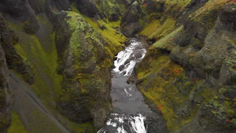 Cascading-Stjornarfoss-waterfall-rapids-in-mossy-rocky-gorge,-Iceland