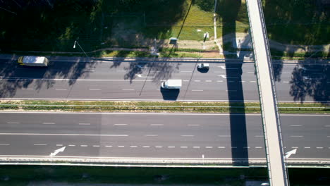 Looking-straight-down-on-a-street-crossing-with-distinct-shadows-from-an-overhead-bridge