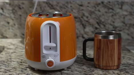 Two-pieces-of-bread-pop-up-in-a-toaster