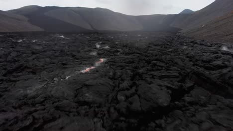 Steaming-black-crust-of-cooling-lava,-Fagradalsfjall-volcano,-Iceland