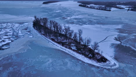 Drone-shot-of-small-island-in-frozen-water