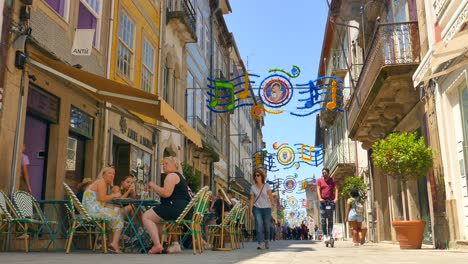 Gente-Cenando-Y-Caminando-Por-La-Calle-Con-Decoraciones-En-La-Ciudad-De-Braga,-Portugal.