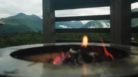 Close-up-shot-of-fire-with-mountains-in-background