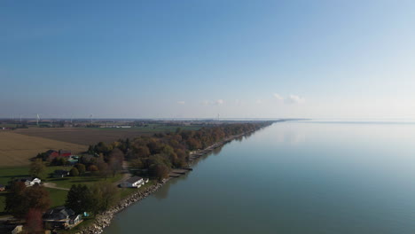 Aerial-dolly-along-rocky-coastline-homes-of-Lake-Erie